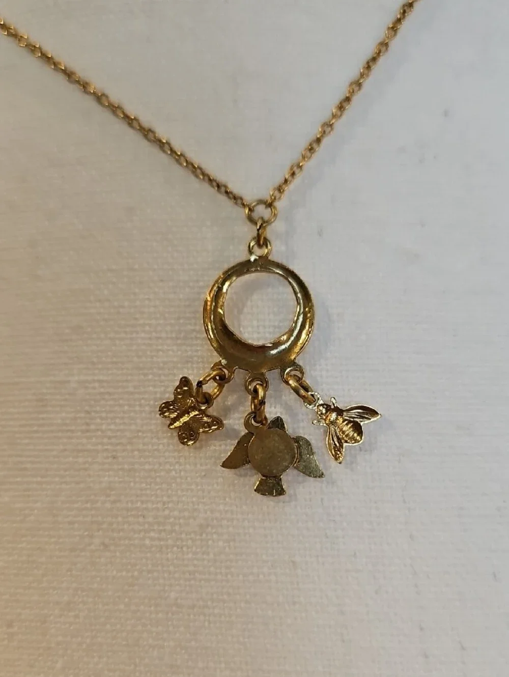 1928 Gold-Tone Circle Necklace with Blue Enamel Bird Bee Butterfly Charms
